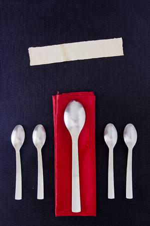 A set of table spoons on a black background.の写真素材
