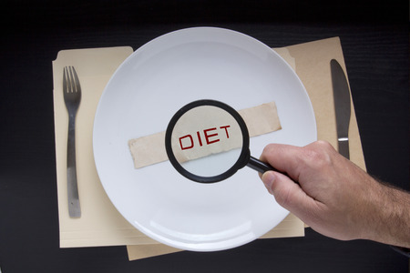 Magnifying glass and text diet on a plate complete with cutlery.の写真素材
