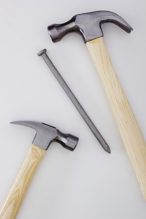 Two construction hammer and big industrial nail.の写真素材