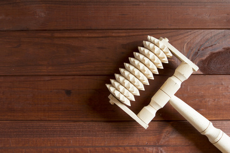 Handmade wooden massager on a wooden surface.の写真素材