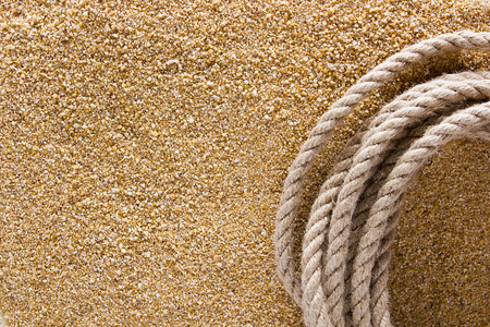 Ship thick rope on the sea sand. Background for travel.の写真素材
