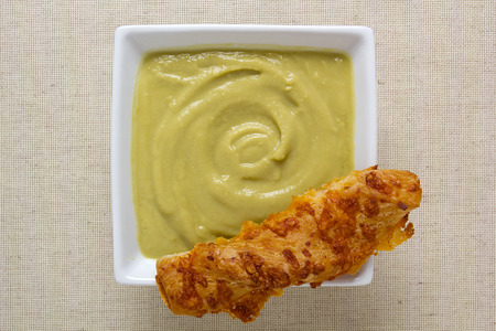 Pea cream soup in a square ceramic plate.の写真素材