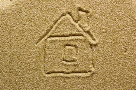 Abstract drawing of a house on sand.の写真素材