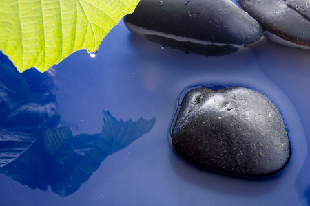 The theme of environmental protection, smooth stones in clean water.の写真素材