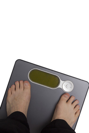Men's feet on the floor scales. Weight control.