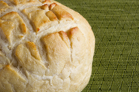 Round bread on kitchen decorative napkin for hygiene.