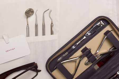 Attention dentist to your nails, manicure set and dental instruments.の写真素材