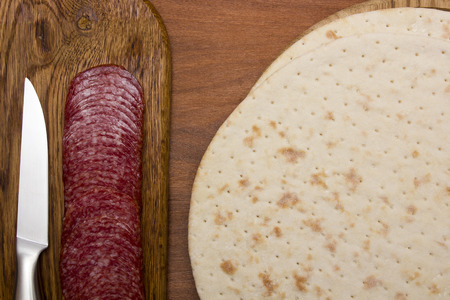 Basic products for pizza - salami and cake.の写真素材