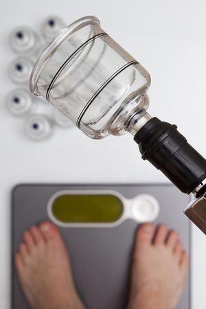 Tools for vacuum massage - weight control on floor scales.の写真素材