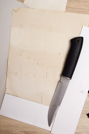The knife in the open folder with documents.の写真素材