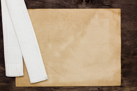 White belt karate - the initial training level. Sheet old paper for information.の写真素材