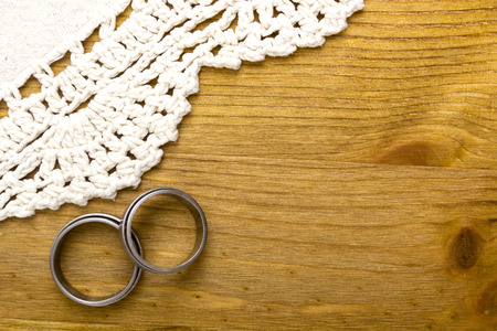 Wedding rings and lace on the wooden backgroundの写真素材