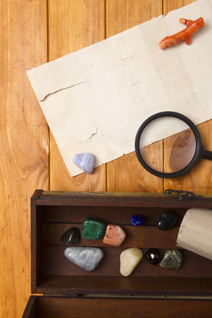 Colored Semi Precious Stones, magnifying glass on a wooden backgroundの写真素材