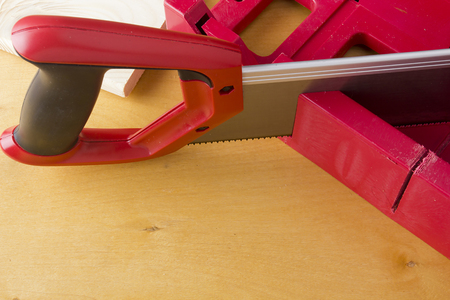 Cutting boards using the miter box and saw on the wooden backgroundの写真素材