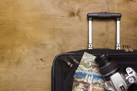 Travelerâs suitcase with  equipment with camera and old pictures on a wooden backgroundのeditorial素材