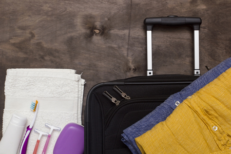Suitcase traveler, toiletries on a wooden background.の写真素材
