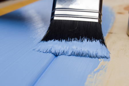 Paintbrush paint wooden board in blueの写真素材