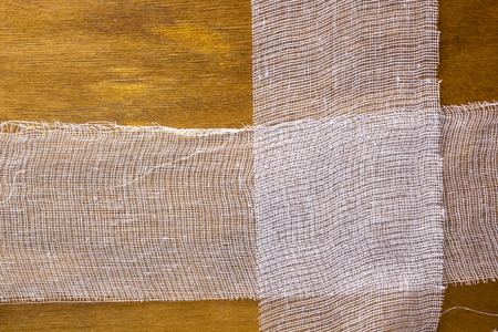White gauze bandage on a wooden backgroundの写真素材