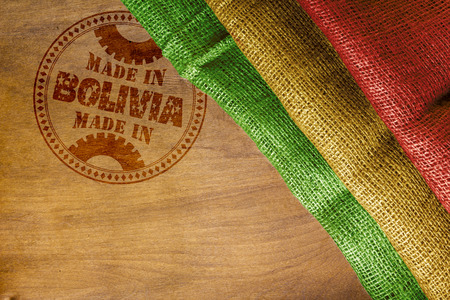 Round the stamp imprint of Made in Bolivia on a wooden surface.の写真素材