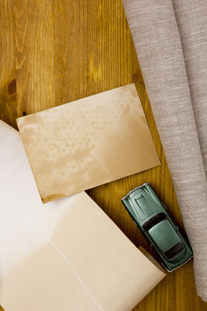 Toy models of cars and a linen cloth on a wooden tableの写真素材