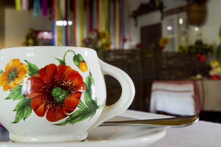 Clay white cup with red floral patternの写真素材