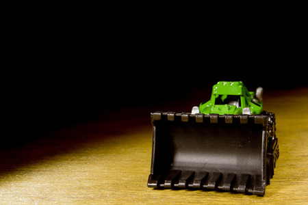 Bright Plastic Digger Toy on a wooden tableの写真素材