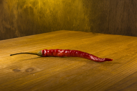 Red chili peppers on a wooden backgroundの写真素材