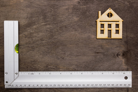 Model house and drawing tools on a wooden tableの写真素材