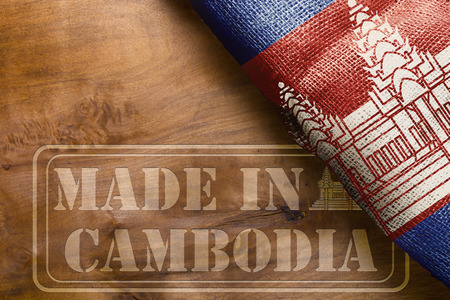 The national flag of the State of Cambodia and marking on a wooden surface Made in Cambodia.の写真素材