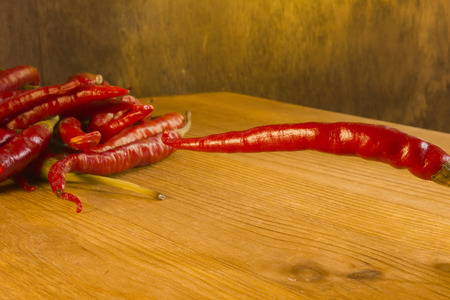 Red chili peppers on a wooden background