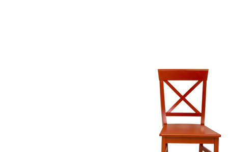 Red wooden chair against a white wallの写真素材