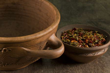 Brown clay piece of plate on a wooden backgroundの写真素材
