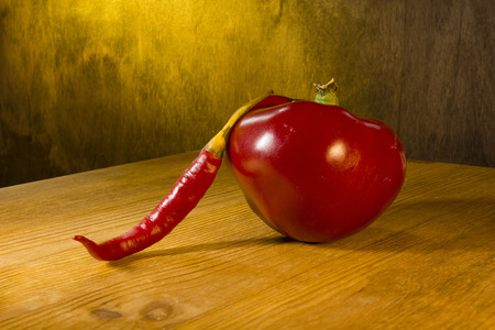 Ripe red pepper on a wooden backgroundの写真素材