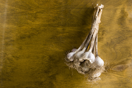fresh garlic bunches on vintage wooden surfaceの写真素材