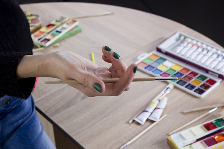 The artists hand drawing a paint, brushes and pencils. Art backgroundの写真素材