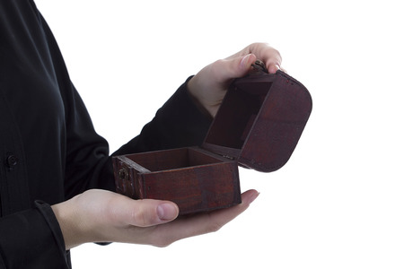 Antique casket in female hands on a white backgroundの写真素材
