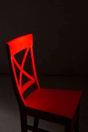 Red wooden chair on a dark backgroundの写真素材