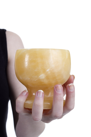 Mortar in the hands of women on a white backgroundの写真素材