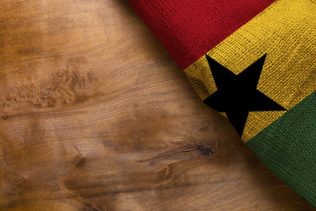 Three-color flag of Ghana on a wooden surface.の写真素材