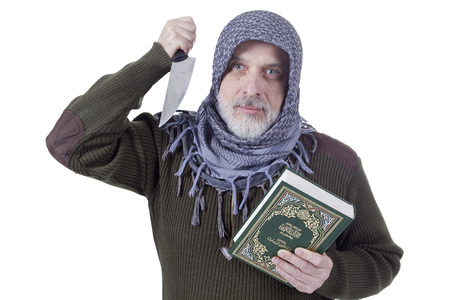 Muslim man with a Koran and a knife on a white backgroundの写真素材