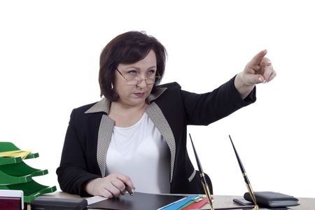 Terrible business woman at the desk on a white backgroundの写真素材