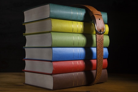 Multicolored book archive pulled by a beltの写真素材