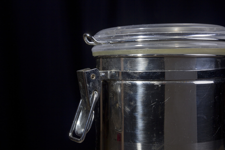 Metal container with a tight lid on a black backgroundの写真素材