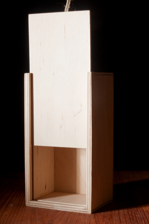 Wooden box as a trap on a black backgroundの写真素材