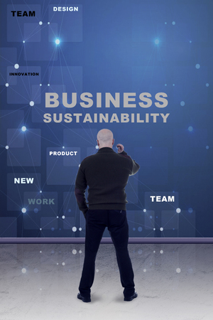 Adult bald man standing in front of business sustainability planの写真素材