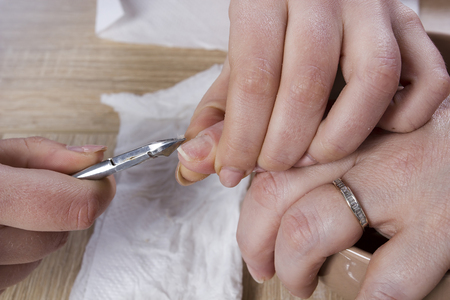 Master in manicure uses a special manicure tool in the beauty salonの写真素材