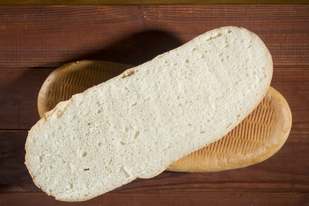 Cut loaf of bread on a wooden surfaceの写真素材