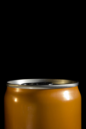 Orange aluminum can close-up on a black background