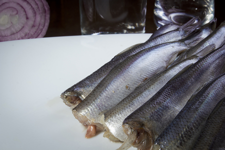 Delicious salted herring on a wooden tableの写真素材