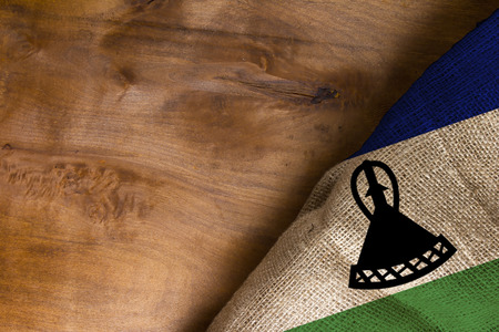 The national flag of Lesotho on a wooden surfaceの写真素材